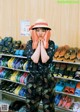 A woman standing in front of a rack of shoes.