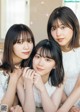 A group of three young women posing for a magazine cover.